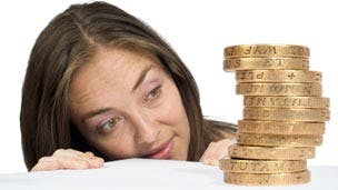 woman looking at stack of coins