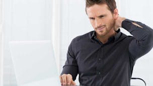 Man sitting at a laptop and looking confused