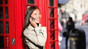 Woman outside red phone box