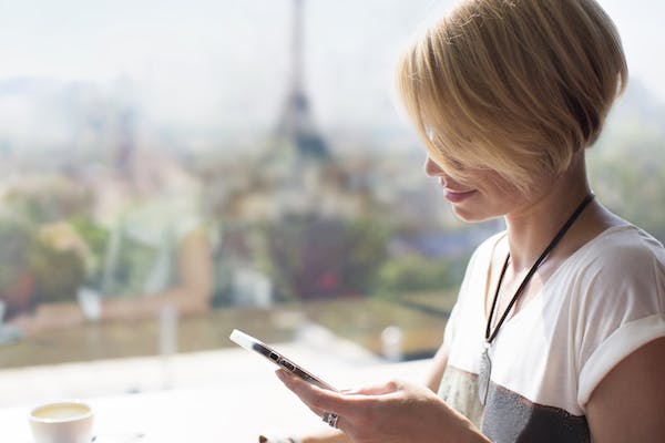 Woman in Paris looking at smartphone