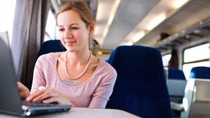 Woman using mobile broadband on train