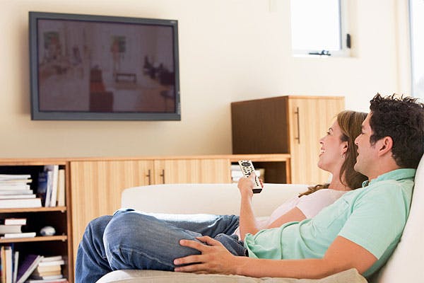 Couple watching TV on the sofa