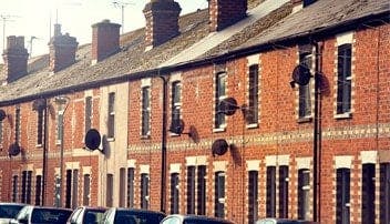 Image of a row of terraced red brick houses 