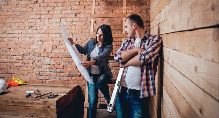 Man and woman looking at building plans