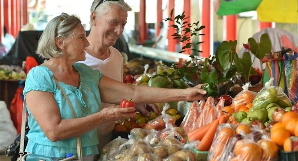 older couple at a fruit market