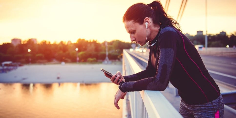 Woman looking at phone after run