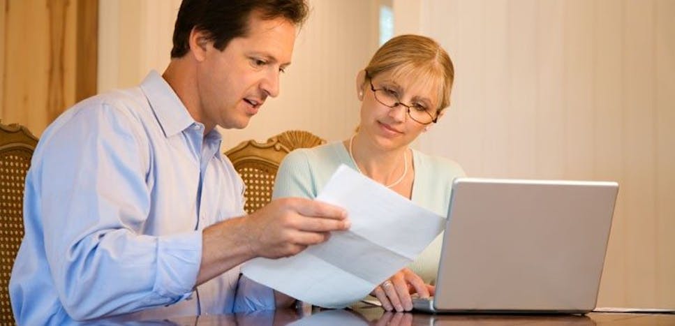 woman with laptop showing MoneySuperMarket on her lap