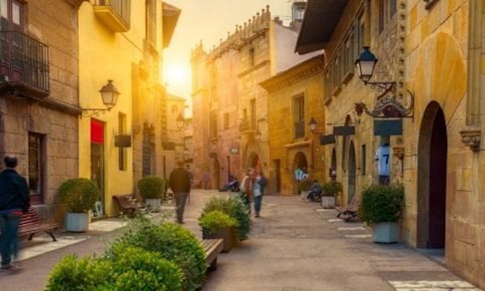 Sunlit Spanish side street with Gothic architecture
