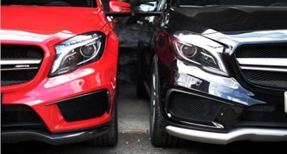 A red and a black car side by side