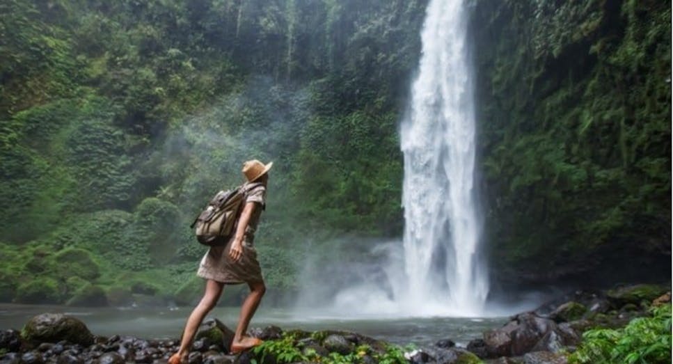 Female traveller exploring waterfall