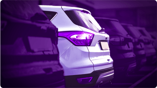 white parked car among purple cars
