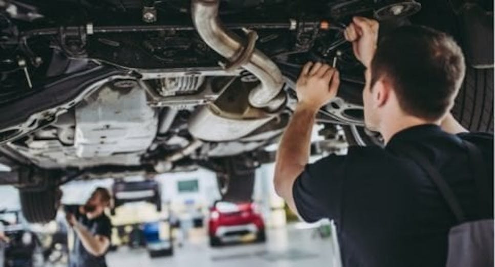Mechanics working on a car in a garage