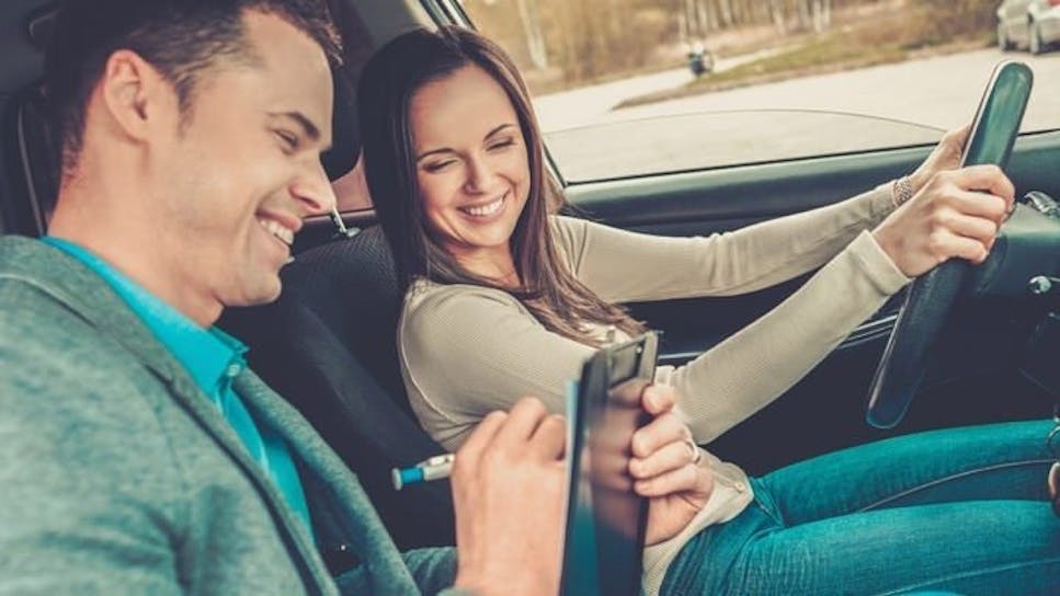 woman with man in car smiling