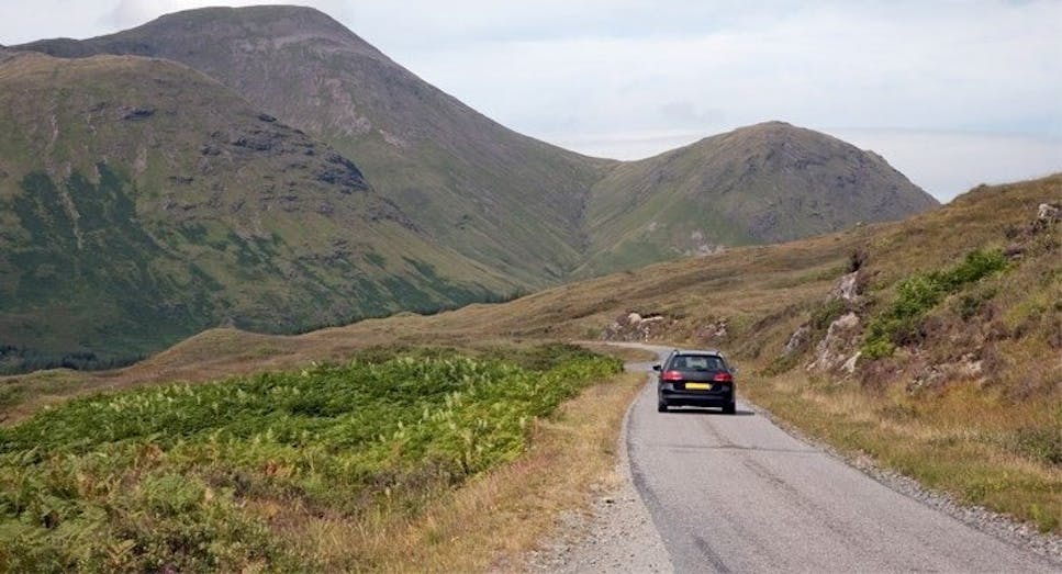 Car on road with mountain backdrop