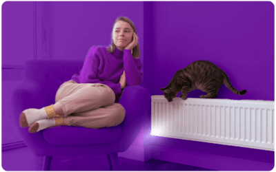 woman and cat sitting next to radiator