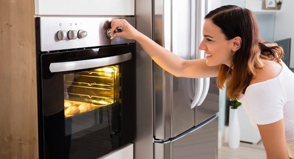 Woman using oven