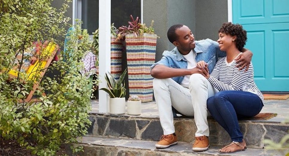 Couple sat outside their home