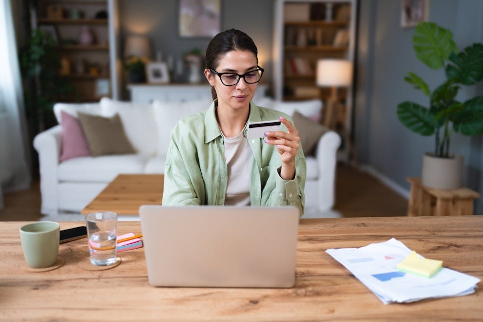 Woman looking at credit card