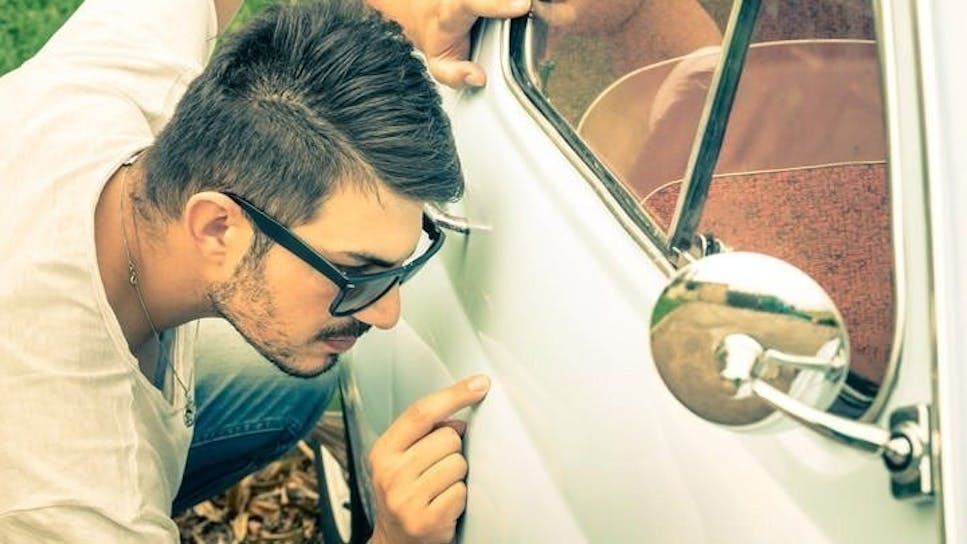Young man checking car