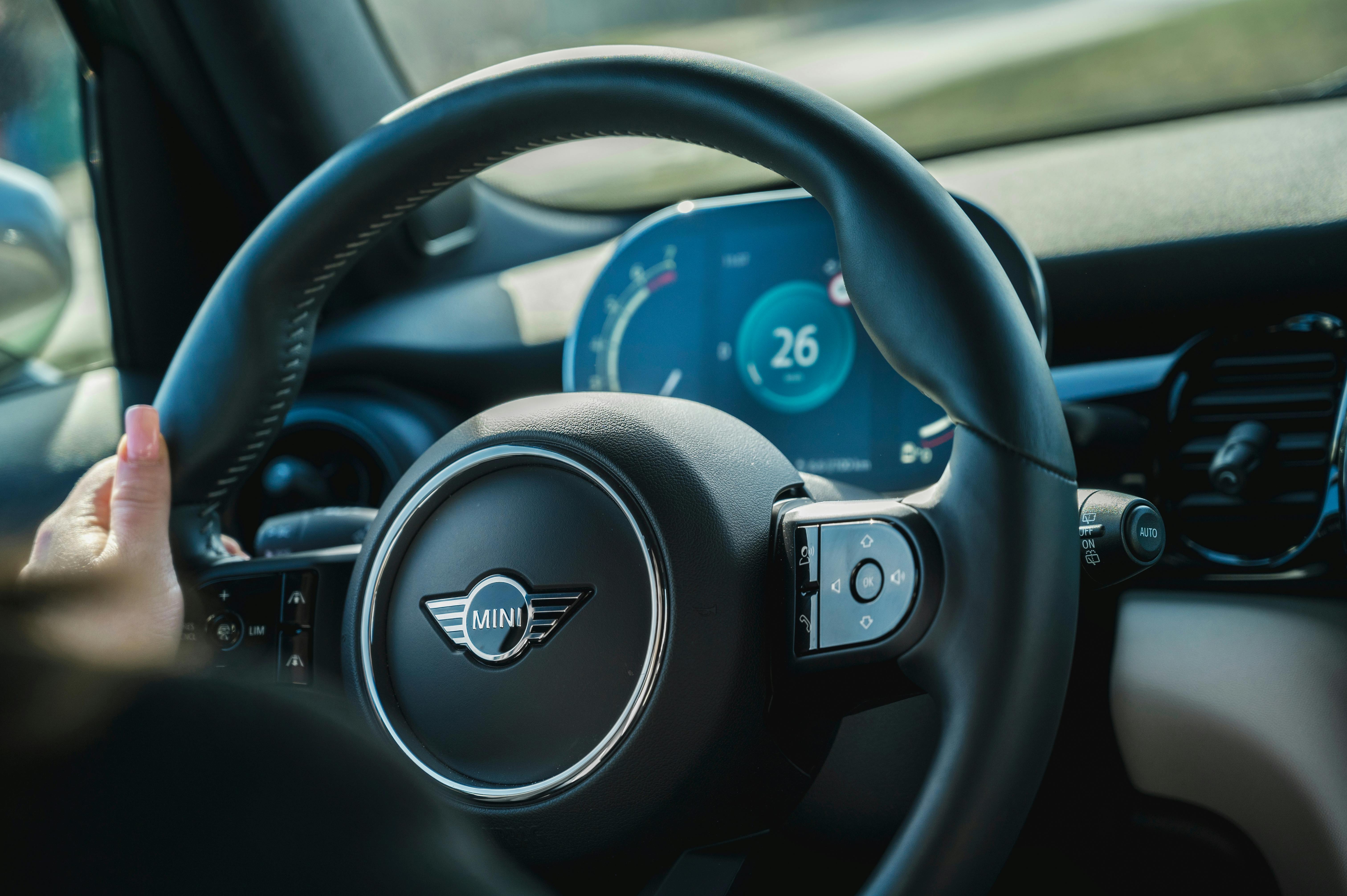Car steering wheel and dashboard while driving
