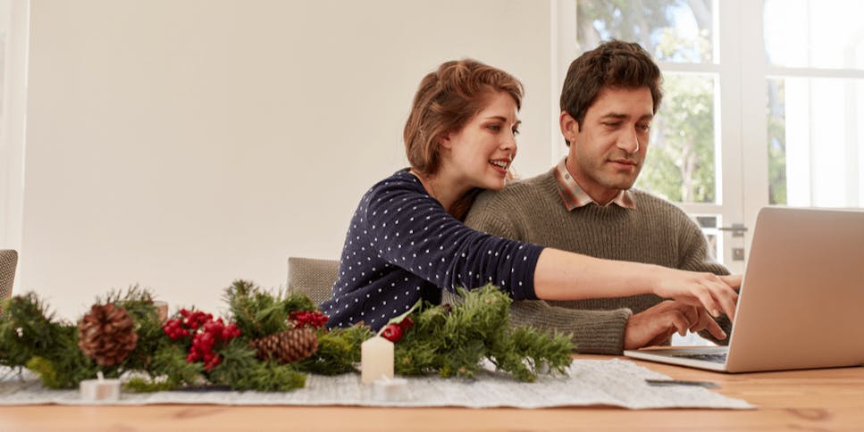 Young couple Christmas shopping online