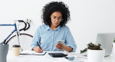 Woman on mobile phone at desk