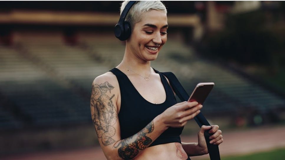 Woman in gym clothes looking at phone