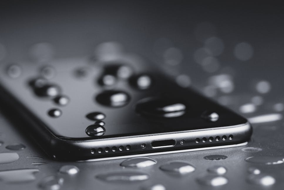 A picture of a wet phone in dark colours 