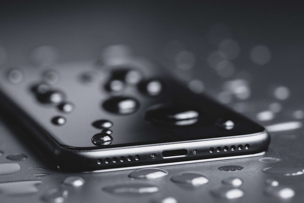 A picture of a wet phone in dark colours