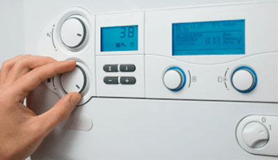 hand adjusting dial on thermostat