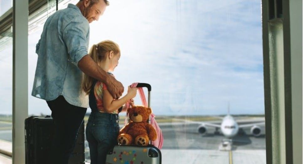 Father and daughter waiting at airport