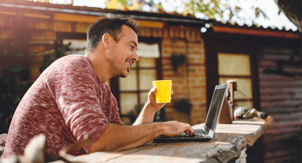 Man on laptop in garden