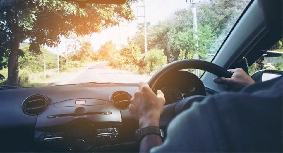 Person driving car down the road