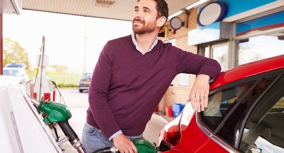 Man putting petrol in car