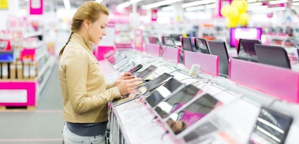 Woman in store playing with tablets