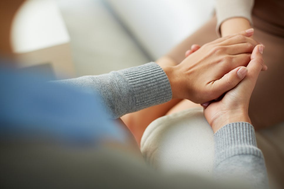 Counsellor holding person's hand