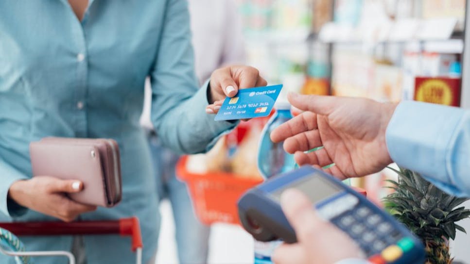 Woman using credit card to pay