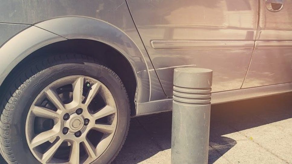 a car scraping against a bollard