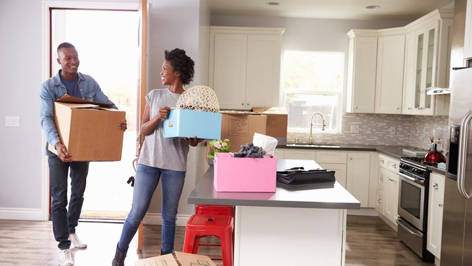 Two young people moving into a new home