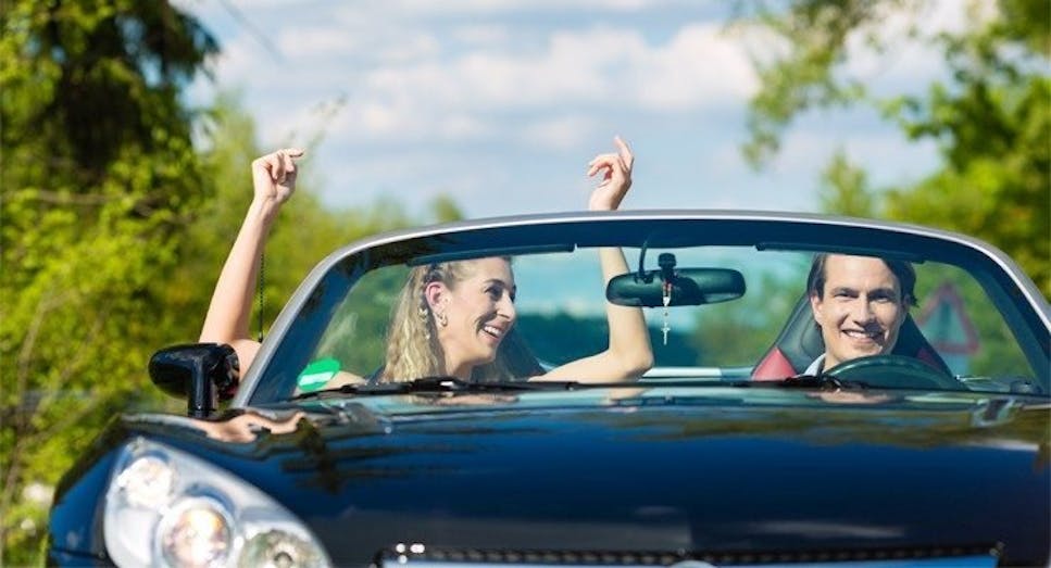 Happy couple in convertible car