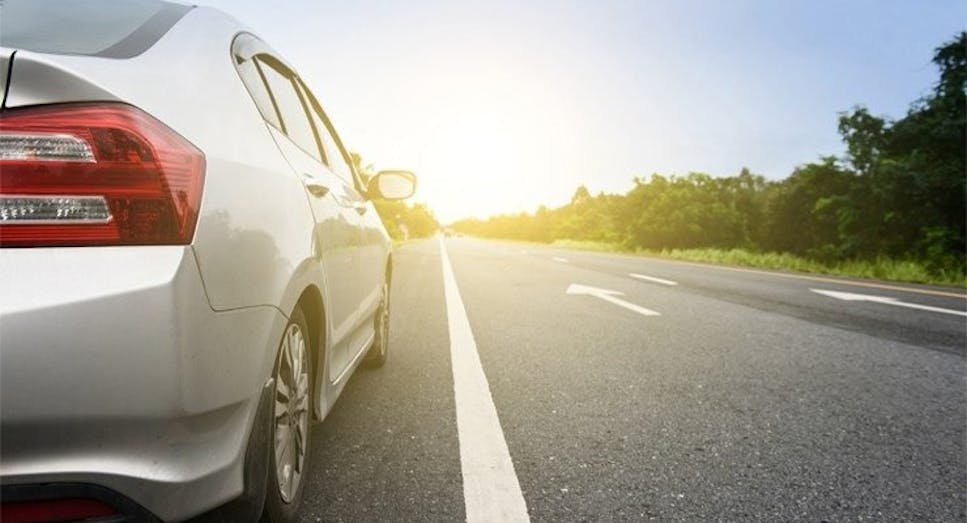 Silver car on sunny road
