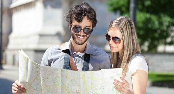 Couple on holiday looking at a map