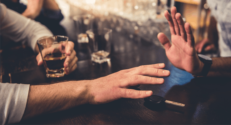 Barman moving car keys away from drunk customer