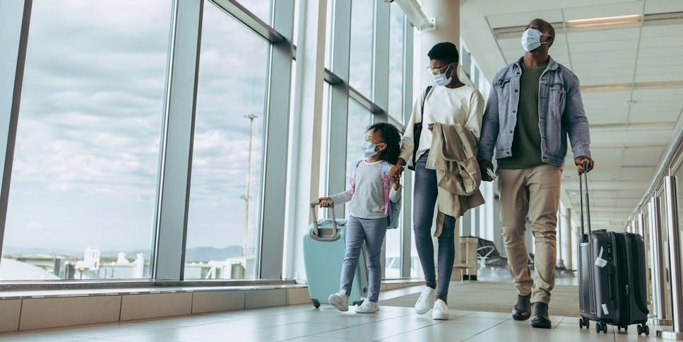 Family walking through airport