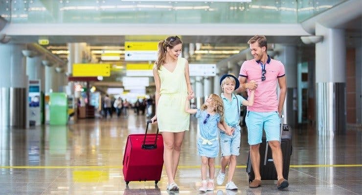 Family walking through airport