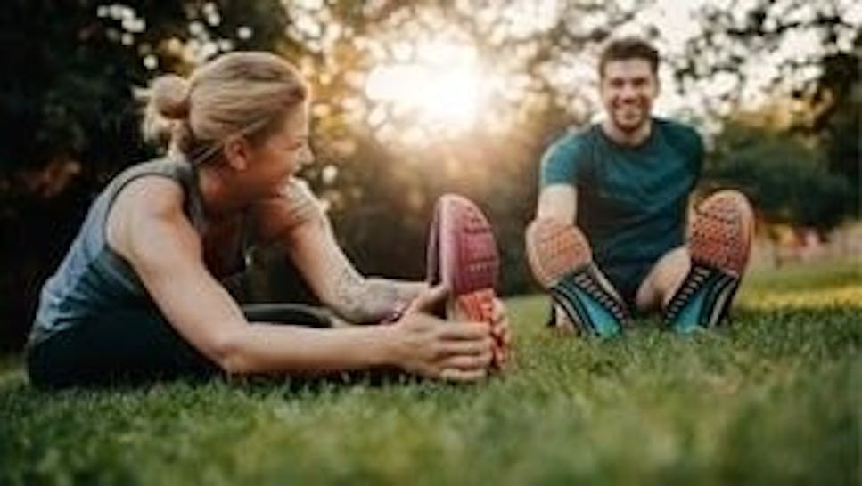man and women stretching after exercise
