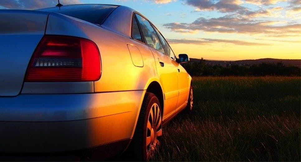 Grey car with sunset backdrop