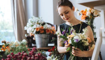 Florist in a shop arranging some flowers