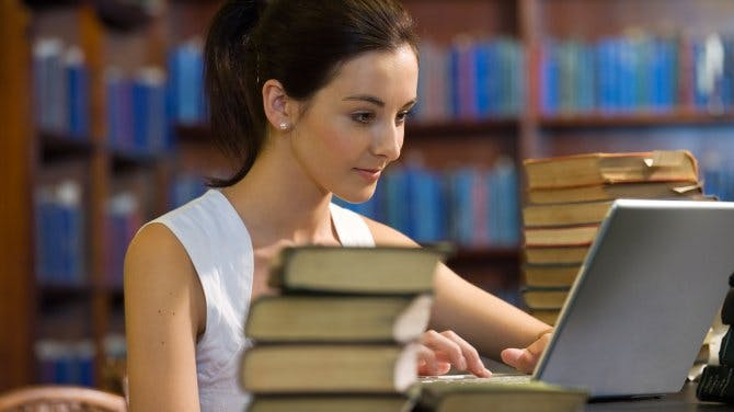 Woman in library on laptop