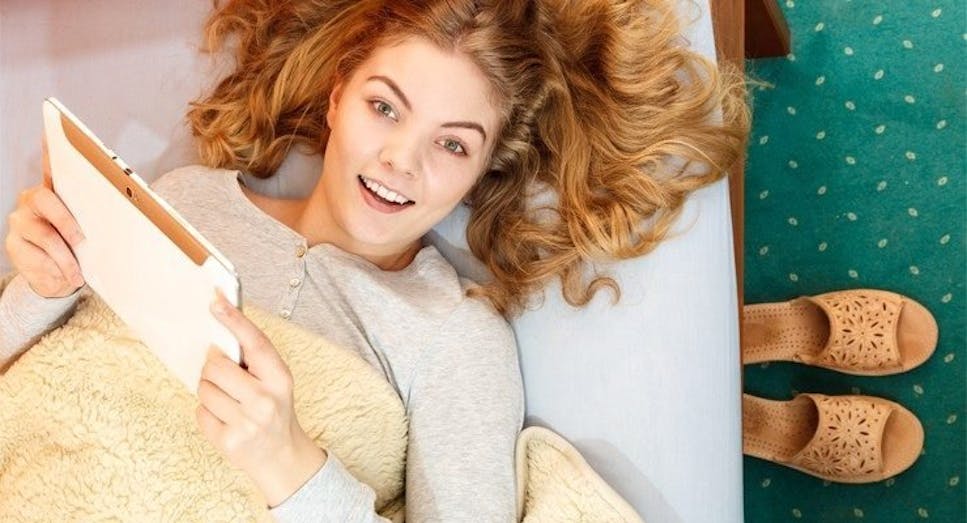 Woman in bed using a tablet